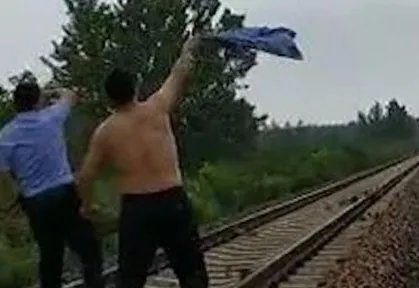 江苏一民警为何挥舞警服拦停火车？