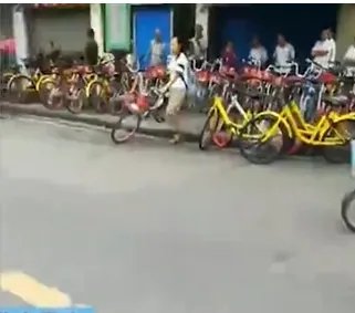 女子将共享单车扔路中间是因为什么？